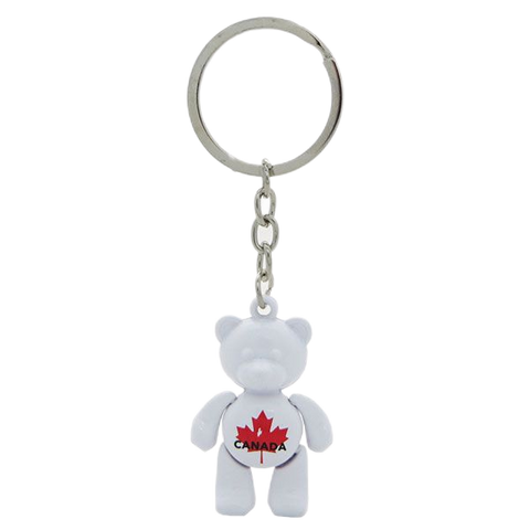 A charming white bear-shaped souvenir keychain from Canada, perfect for adding a touch of Canadian wilderness to your keys or bag