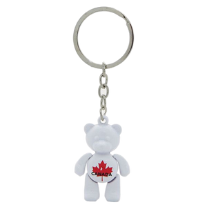 A charming white bear-shaped souvenir keychain from Canada, perfect for adding a touch of Canadian wilderness to your keys or bag